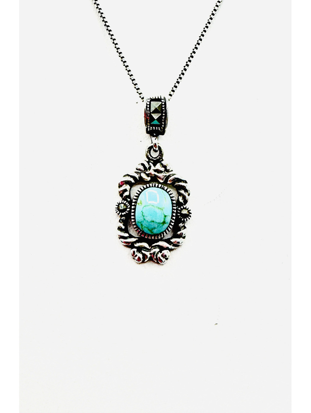 Sterling silver box chain with turquoise cabochon in scrolling frame